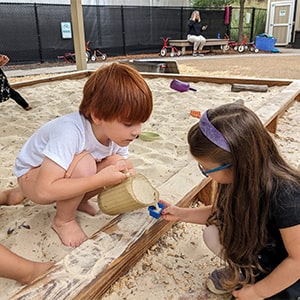 Students playing in the sandbox