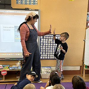 A student and teacher high-five