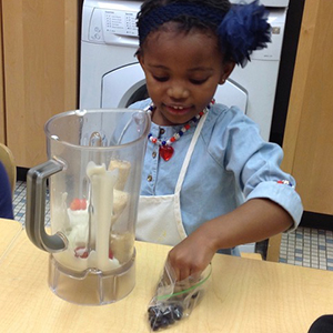 Child using a blender in the kitchen