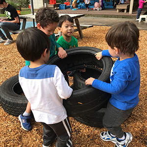 Children working together to move a tire