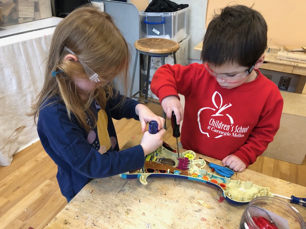 Students dismantling a toy in the Make Shop