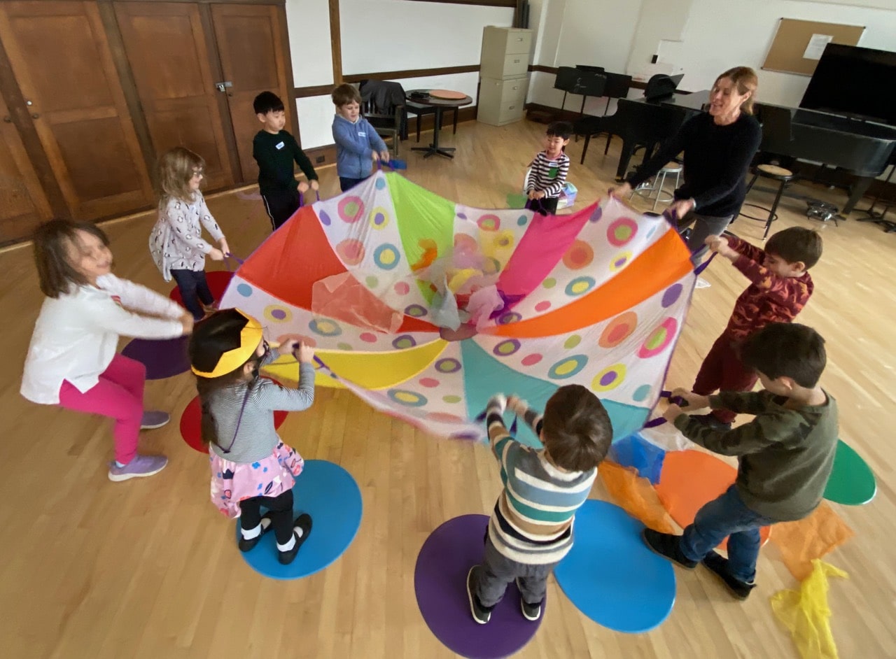 Students playing with the parachute