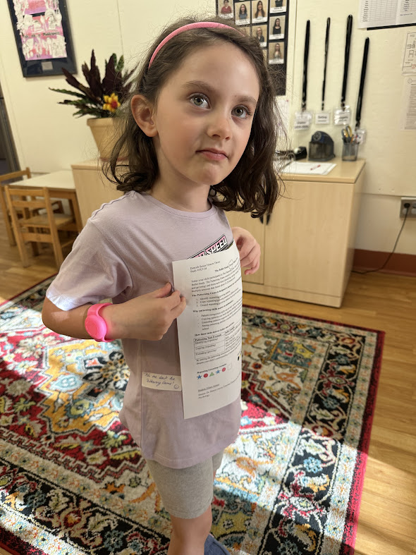 a child wearing a research sticker