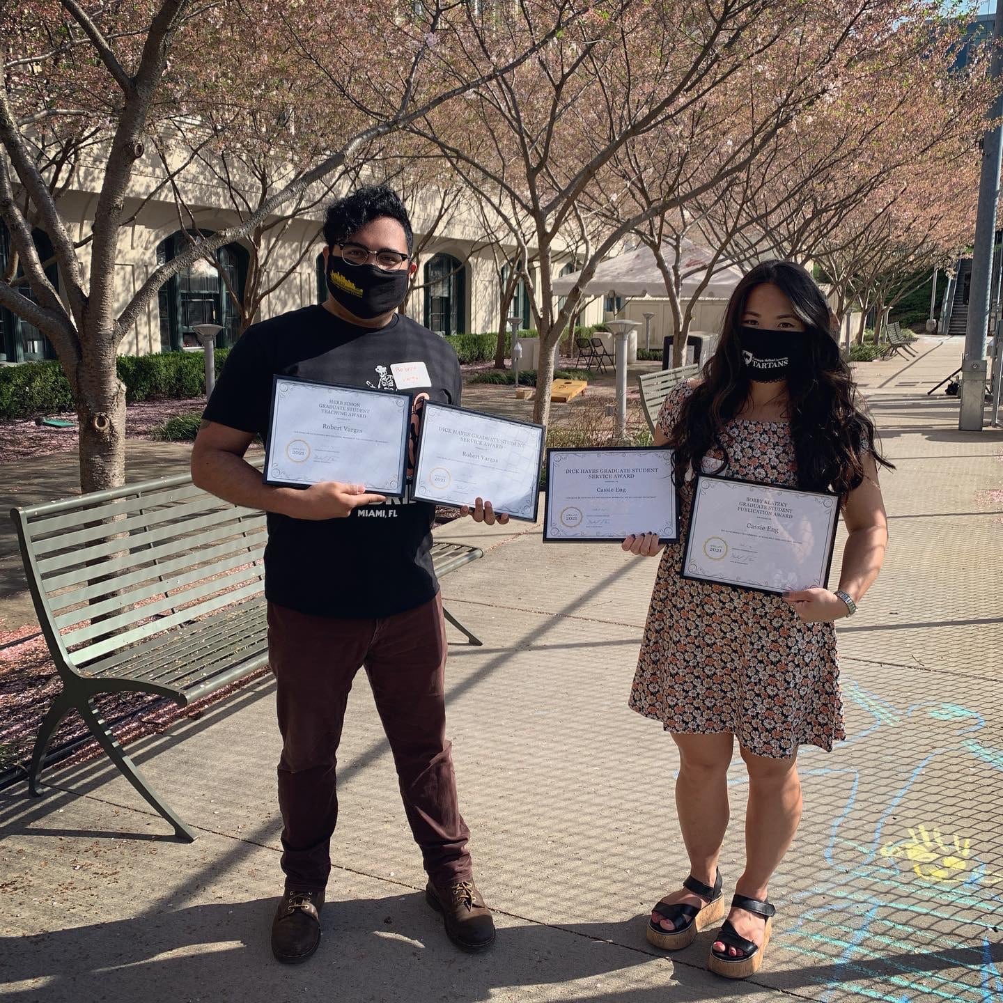 Cassie Eng and Robert Vargas holding their framed awards