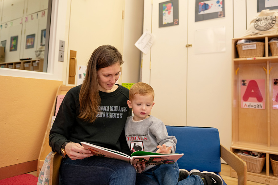 An adult and child reading.