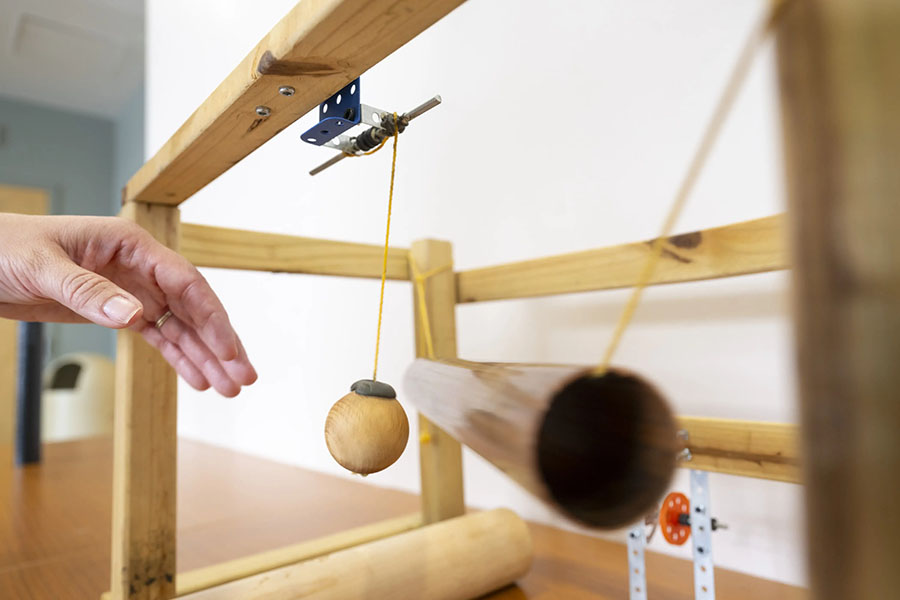 a ball contacts a suspended tube