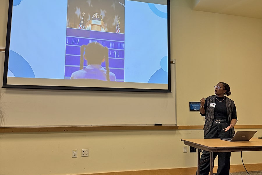 Camille presenting her work at the 2025 Meeting of the Minds
