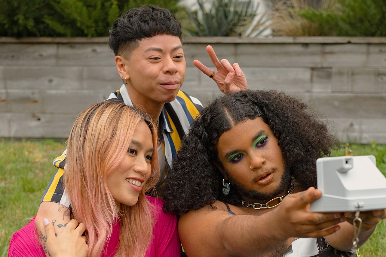 three people pose for a selfie