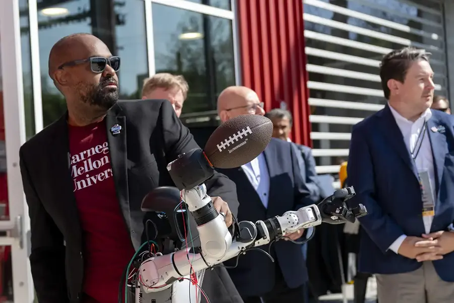 ETC Director Derek Ham shows off a robot that can throw a football