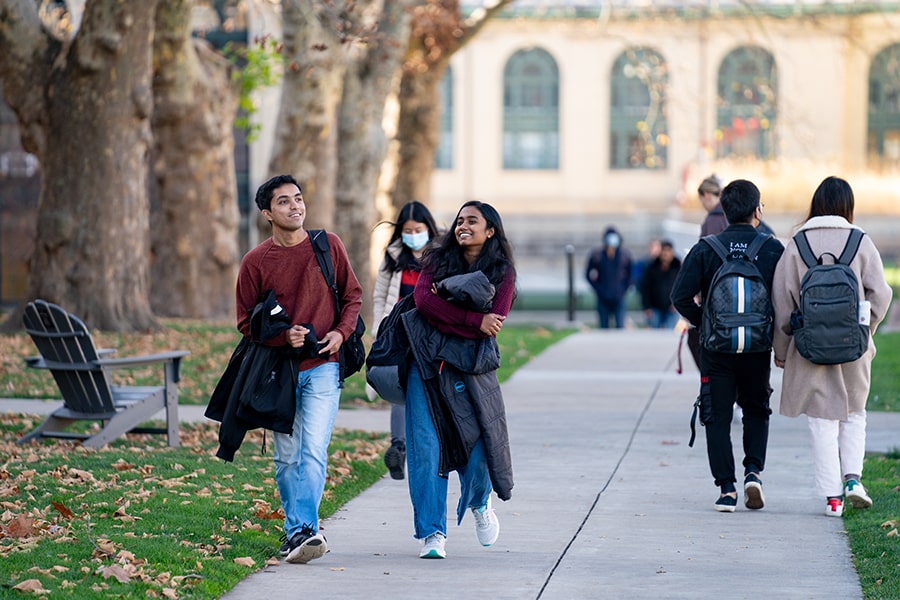 students walking on campus on a fall day