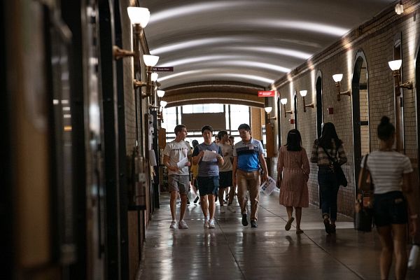 Students walk down a Baker Hall cooridor.