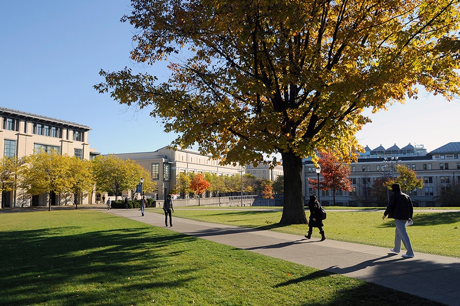 students walking across the cut towards the Cohon Center on a sunny fall day