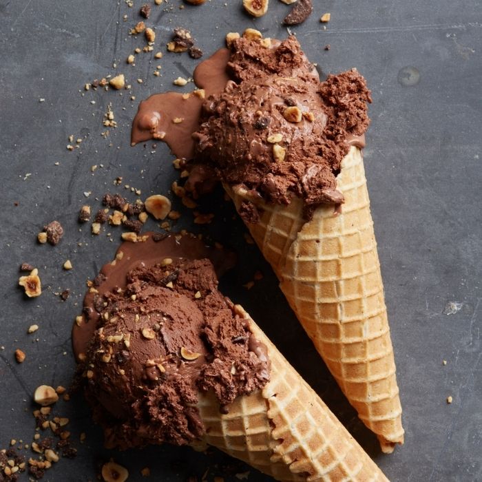 chocolate ice cream and almonds on a waffle cone