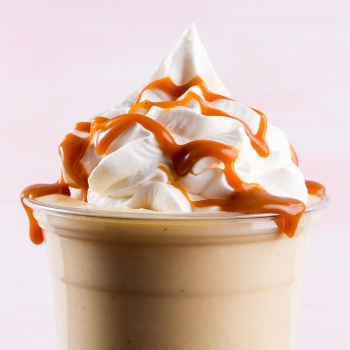 milkshake topped with whipped cream and caramel drizzle