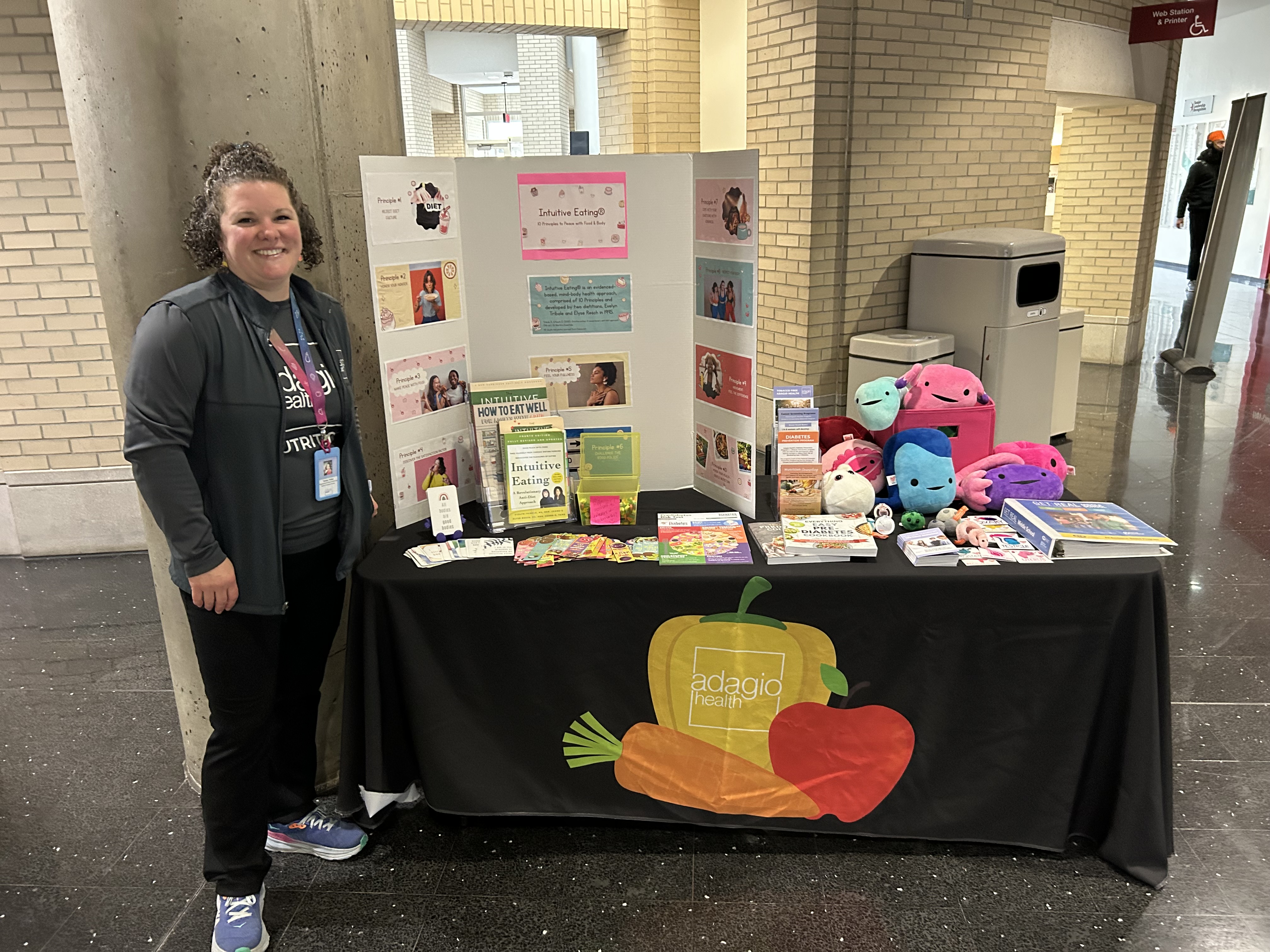 Person standing next to table display for Adagio Health