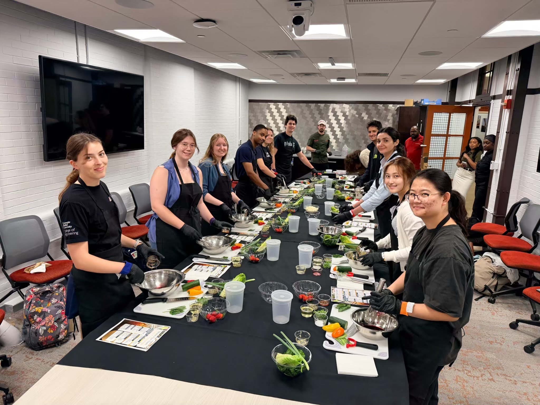 group of students at a table preparing food