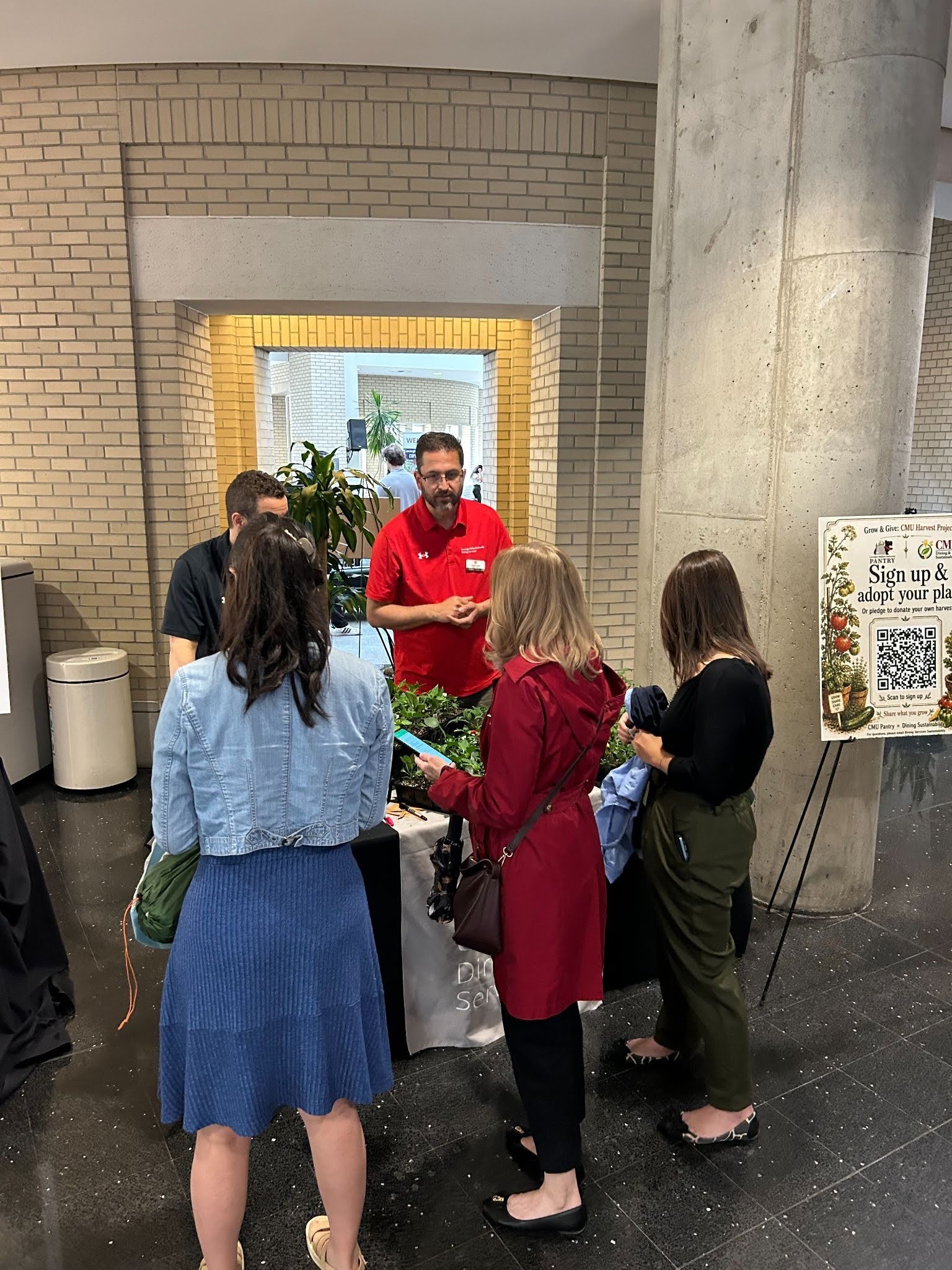 CMU staff at Grow and Give seedling table