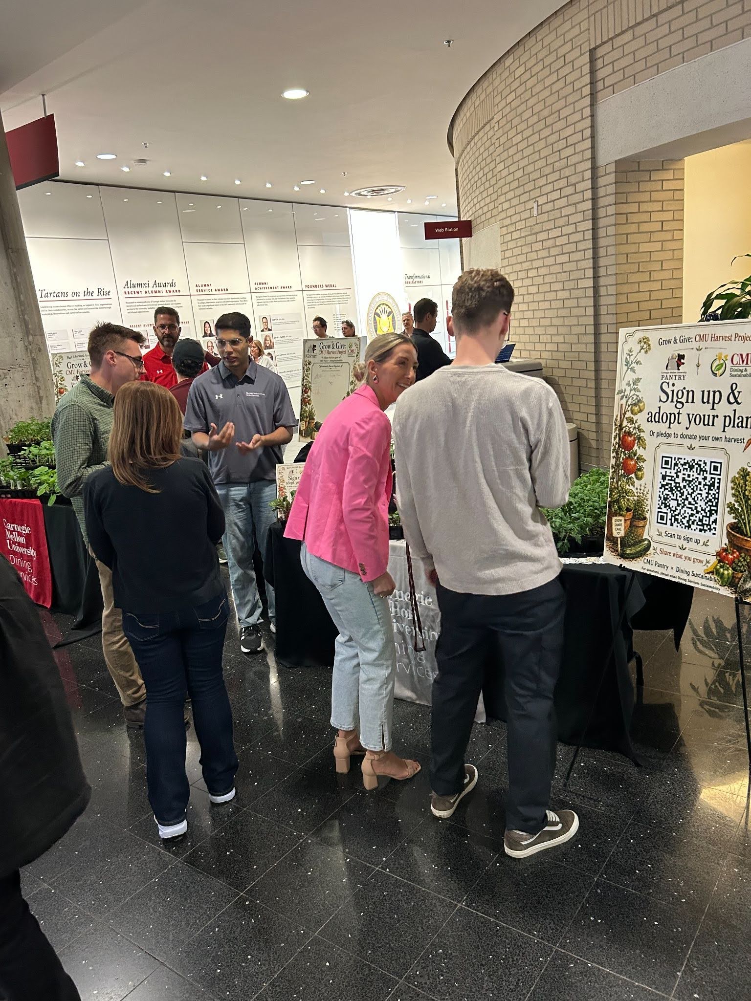 CMU staff selecting seedlings from the Grow and Give table