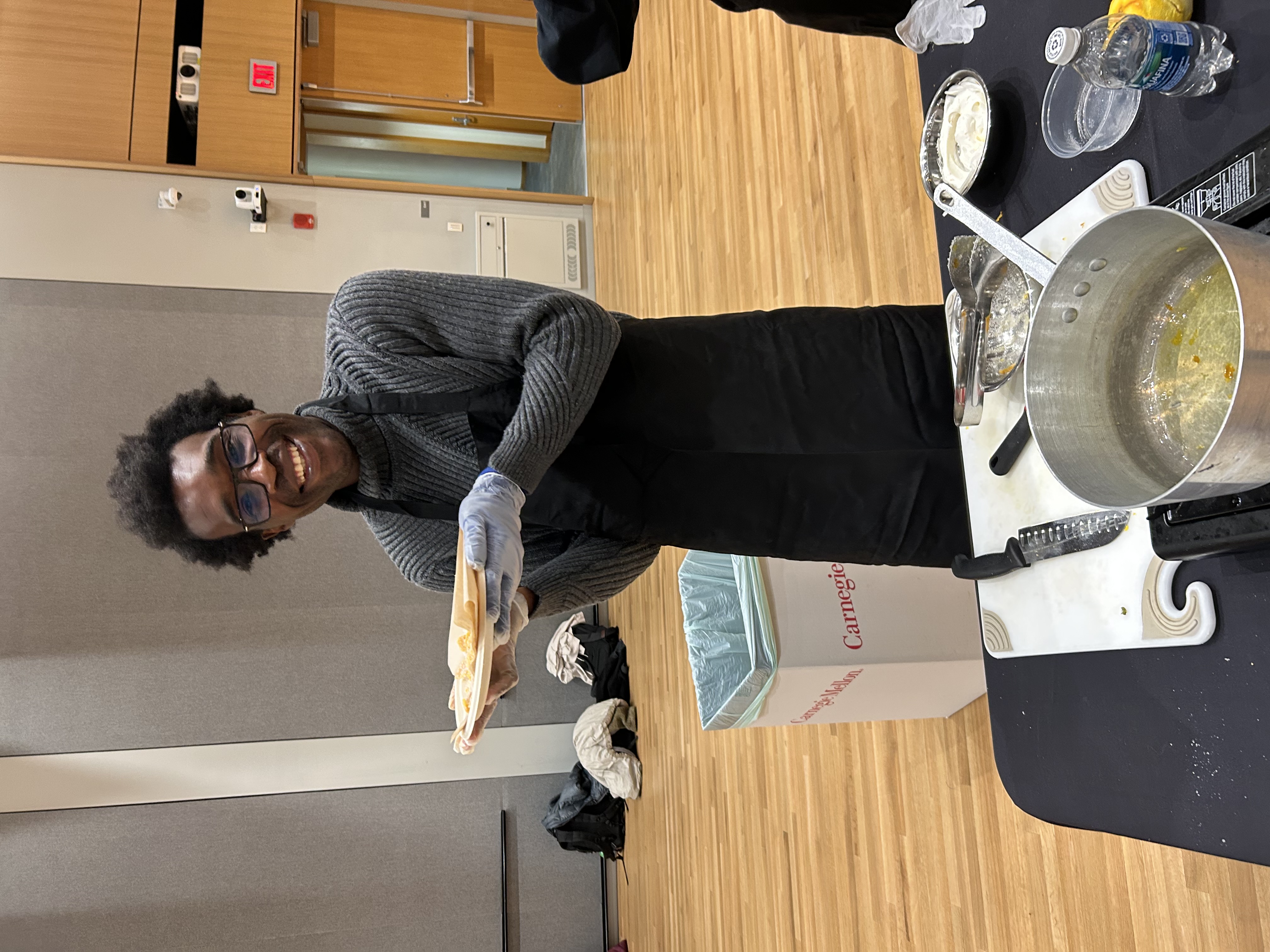 students holding plate of homemade food