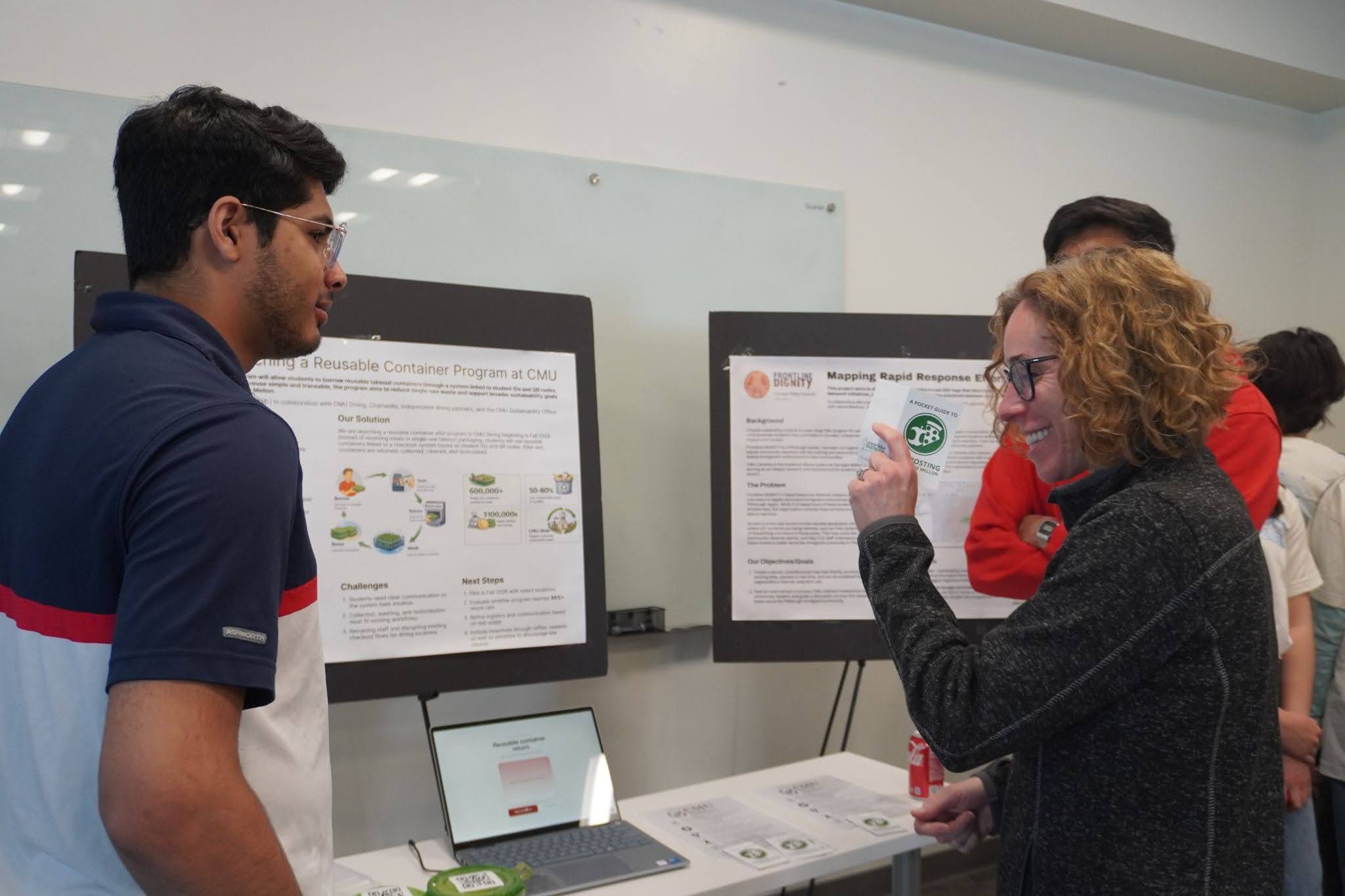 students standing at their presentation table