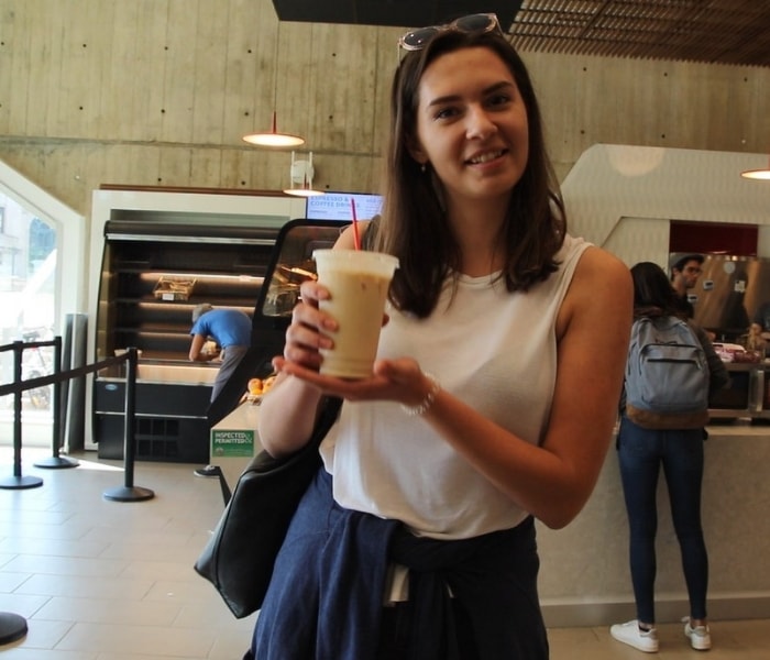 student holding latte