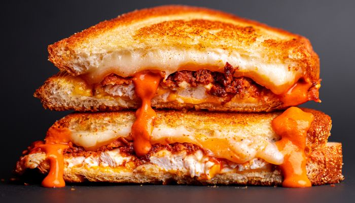 grilled sandwich with melted cheese and buffalo chicken