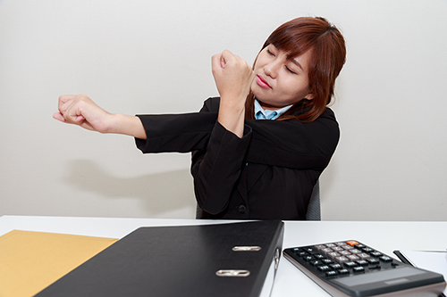 woman performing desk exercises