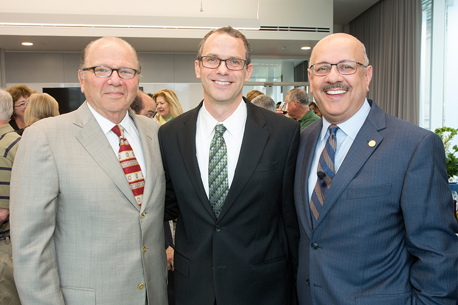 CMU interim president farnam jahanian and former scott institute director jared cohon stand with Jay Whitacre. 