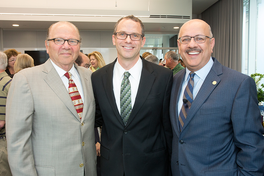 CMU interim president farnam jahanian and former scott institute director jared cohon stand with Jay Whitacre. 
