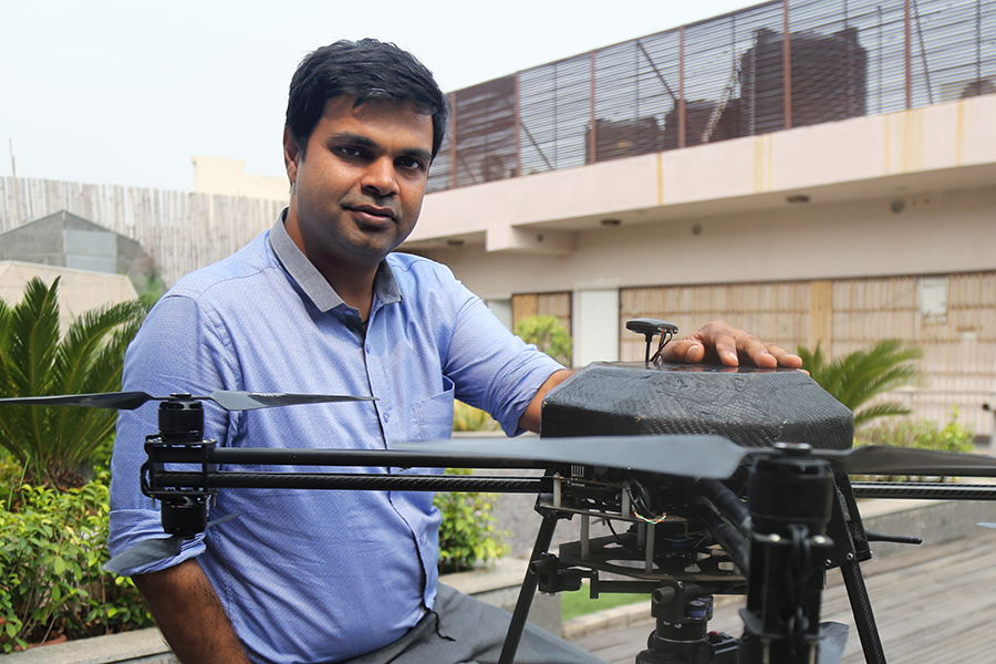 Aakash Sinha seated next to a drone