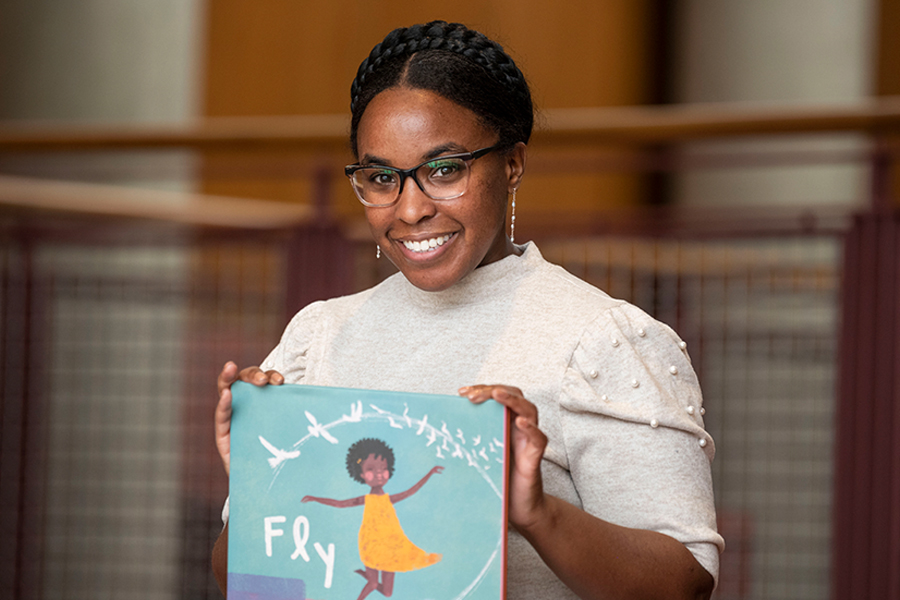 Photo of Brittany Thurman holding her book "Fly"