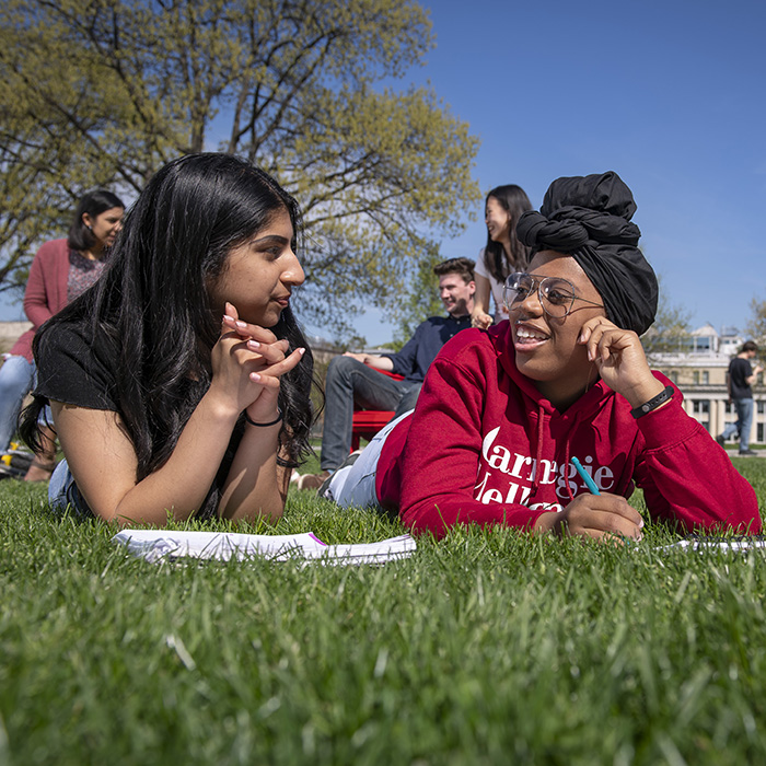 Students lay in grass