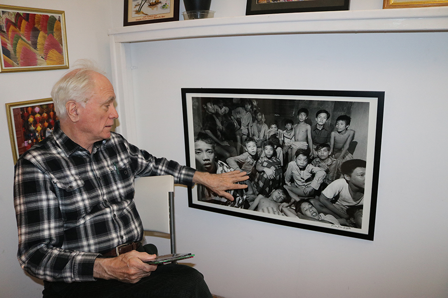 Photo of Dick Hughes showing one of his pictures on display