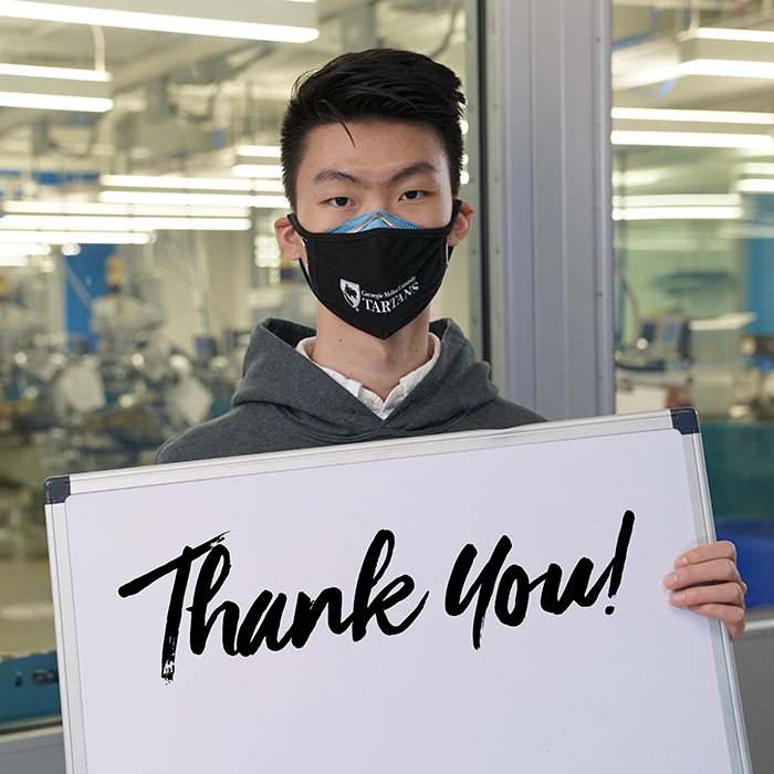 Photo of student holding thank you sign