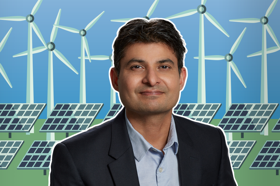 Photo of alumnus Abhi Sharma in front of windmills and solar panels