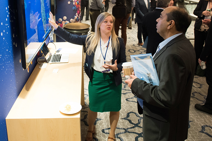 Krista Kinnard speaking with someone in front of a screen