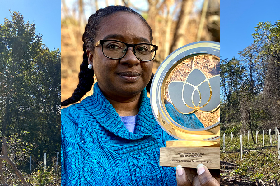 Photo of Tiffany Taulton in the woods holding awardwith aircraft carrier