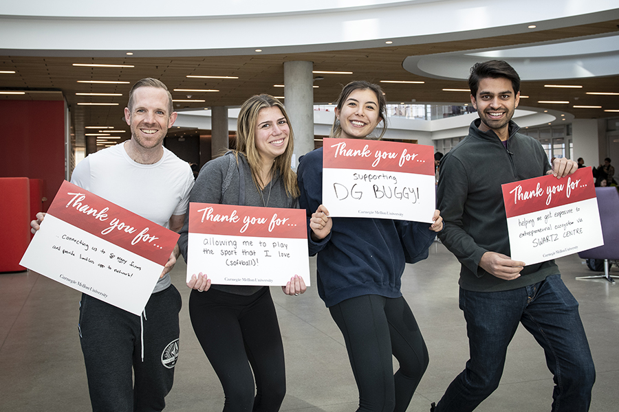 Students Hold Sign Thanking Donors