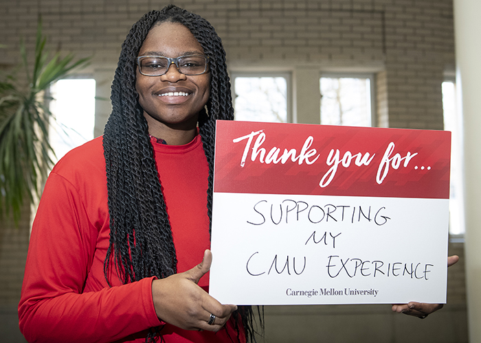 CMU Students Hold Sign Thanking Donors