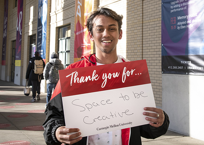 CMU Students Hold Sign Thanking Donors