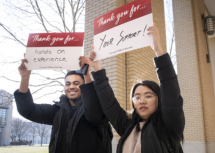 CMU Students Hold Sign Thanking Donors