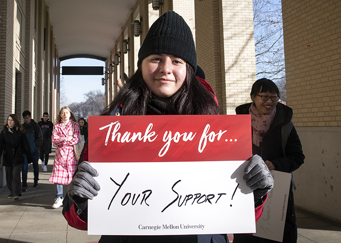 CMU Students Hold Sign Thanking Donors