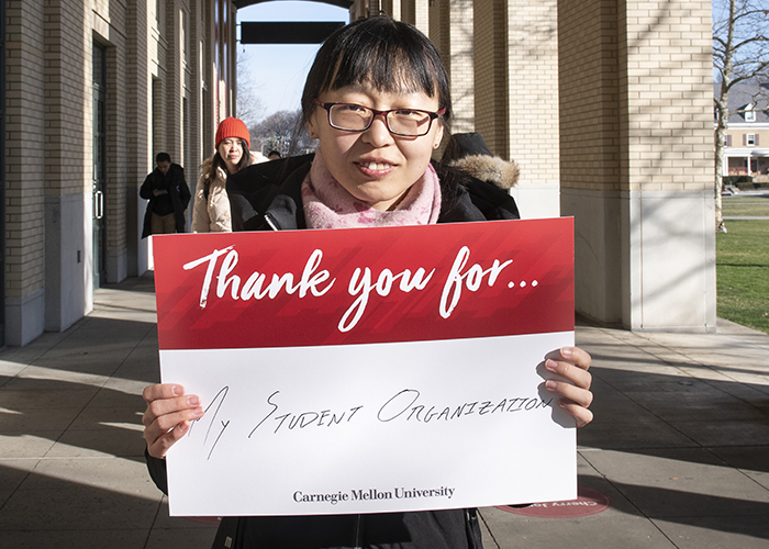 CMU Students Hold Sign Thanking Donors