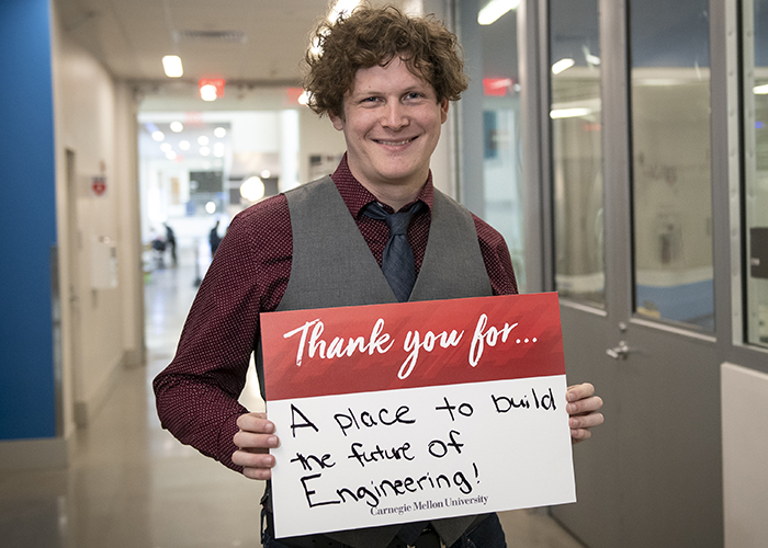 CMU Students Hold Sign Thanking Donors