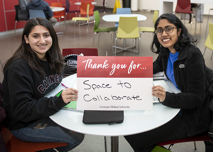 CMU Students Hold Sign Thanking Donors