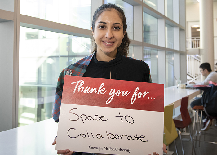 CMU Students Hold Sign Thanking Donors