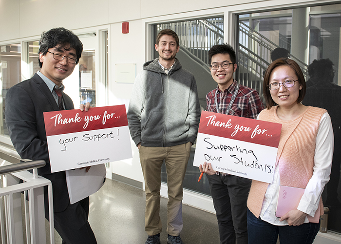 CMU Students Hold Sign Thanking Donors