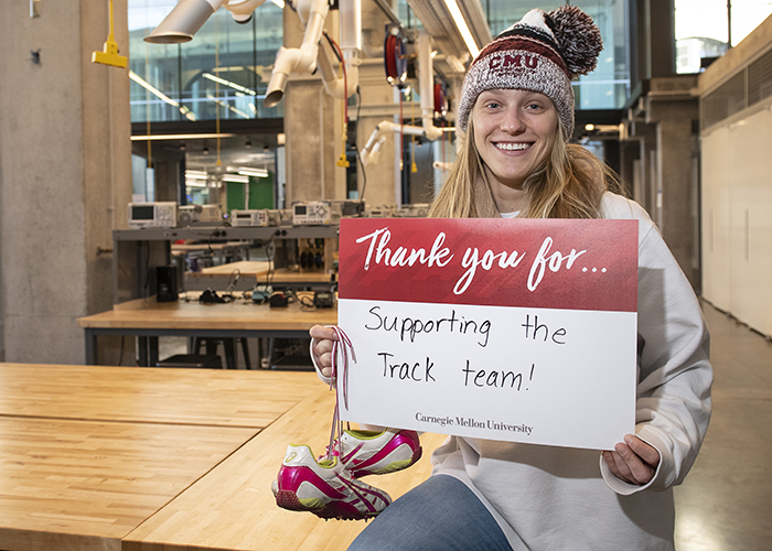 CMU Students Hold Sign Thanking Donors