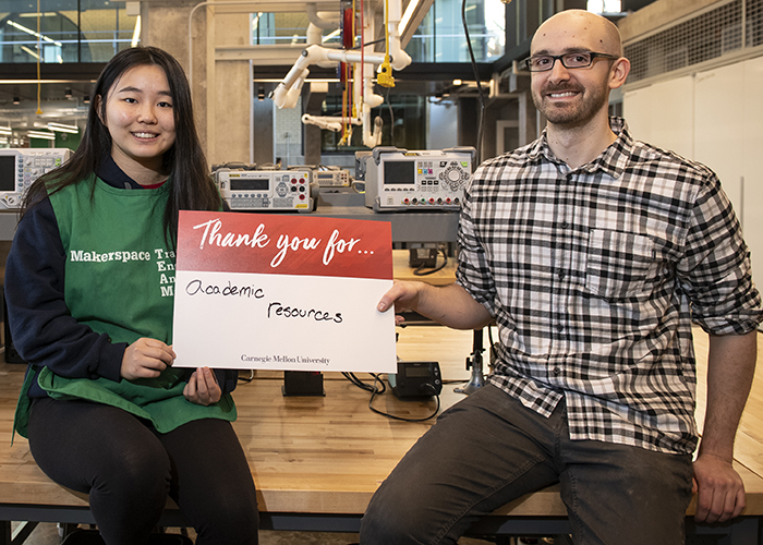 CMU Students Hold Sign Thanking Donors