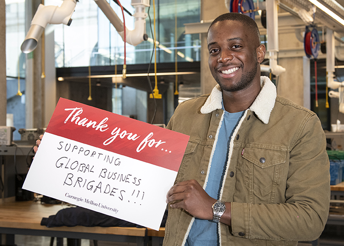 CMU Students Hold Sign Thanking Donors